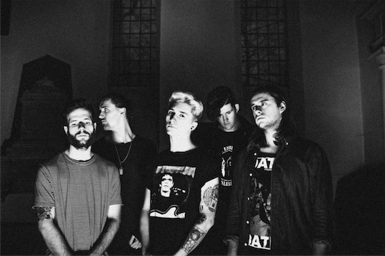 Holding Absence sign to Sharptone Records